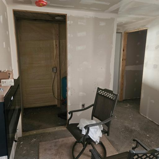 utility room and portion of main living area with electric fire place.JPG