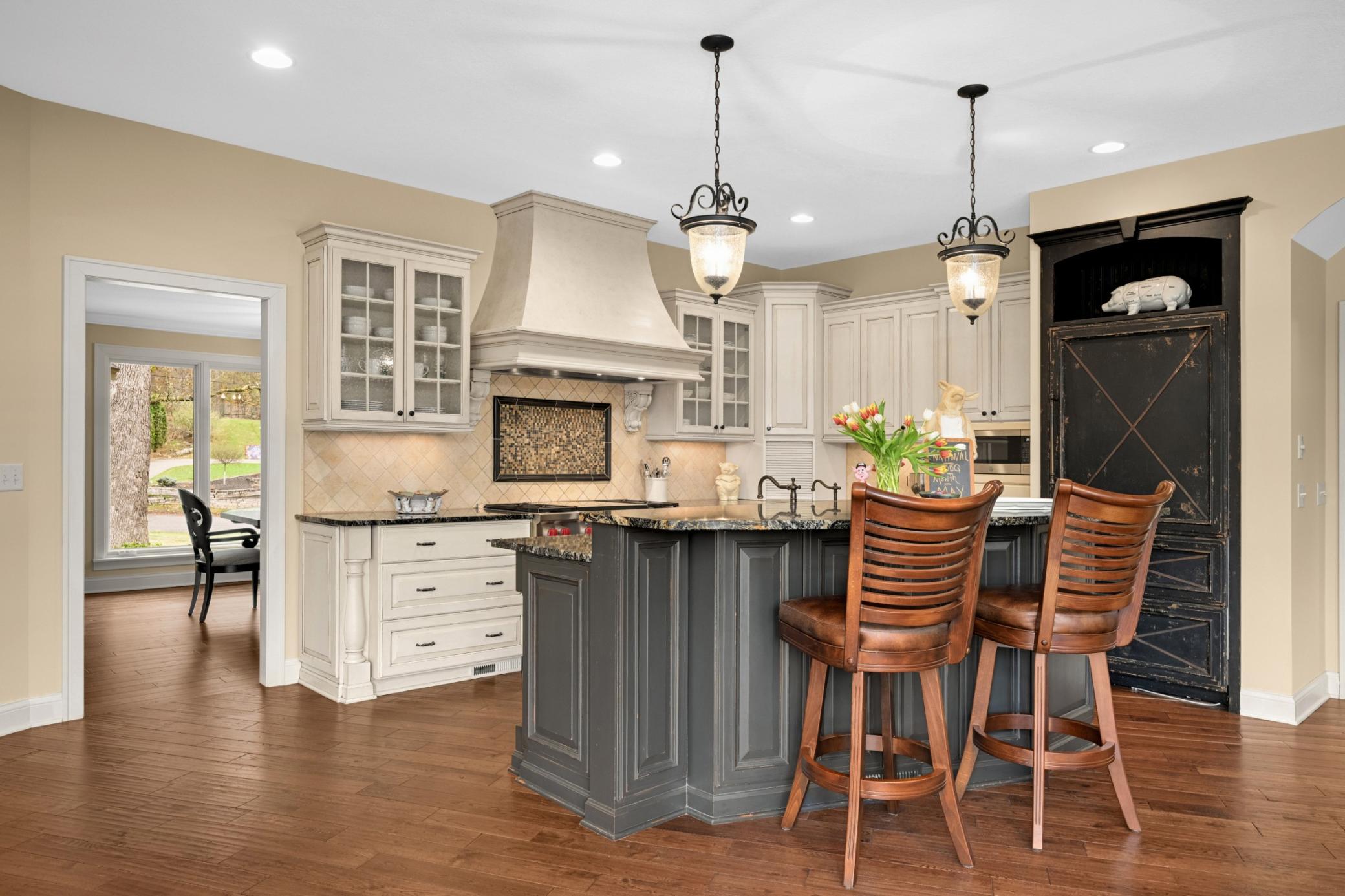 A beautifully appointed center island gourmet kitchen with high-end appliance and breakfast bar