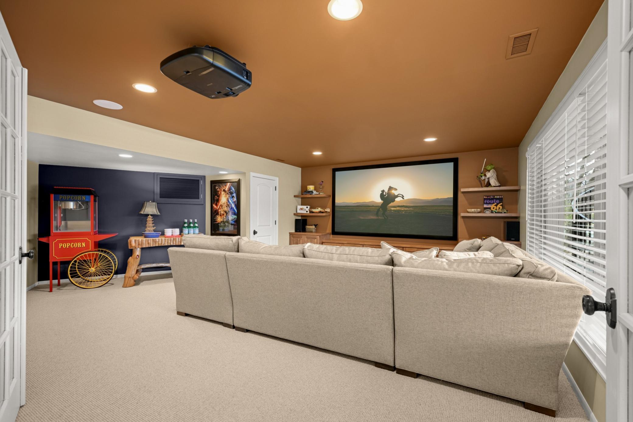 The redesigned theater room has a wall of new built-in for storage and the TV plus a closet if needed for a fifth bedroom.