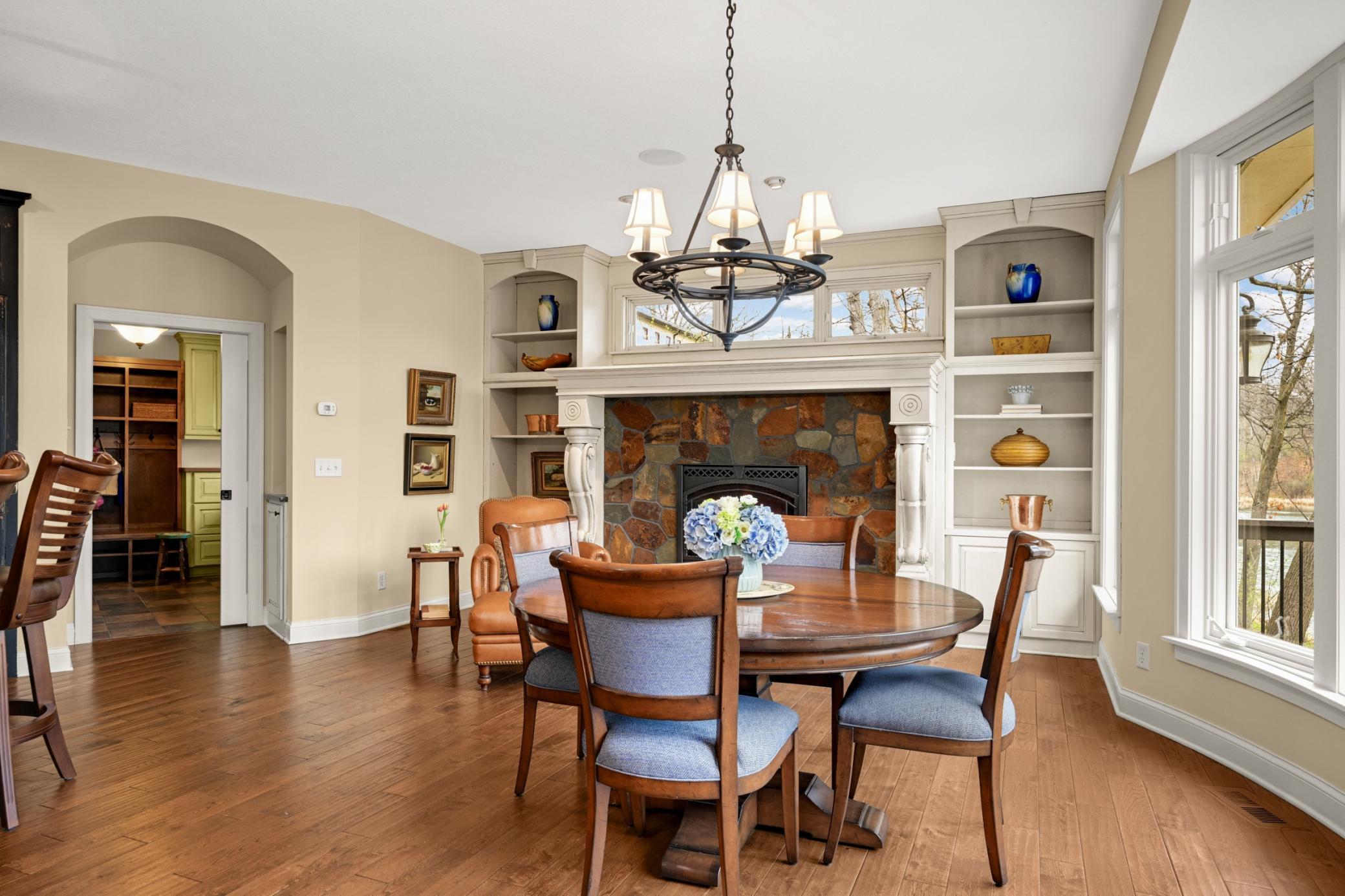The stunning Heath room features a gas fireplace with a slate around and a spectacular mantle flanked by built-ins and transom windows above