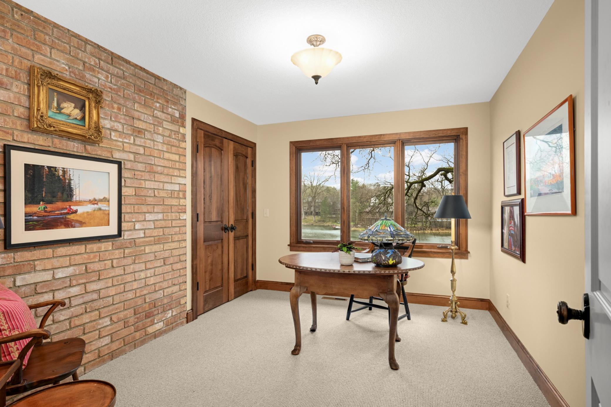 The main floor office/second bedroom has three big windows to the lake and a good-sized closet
