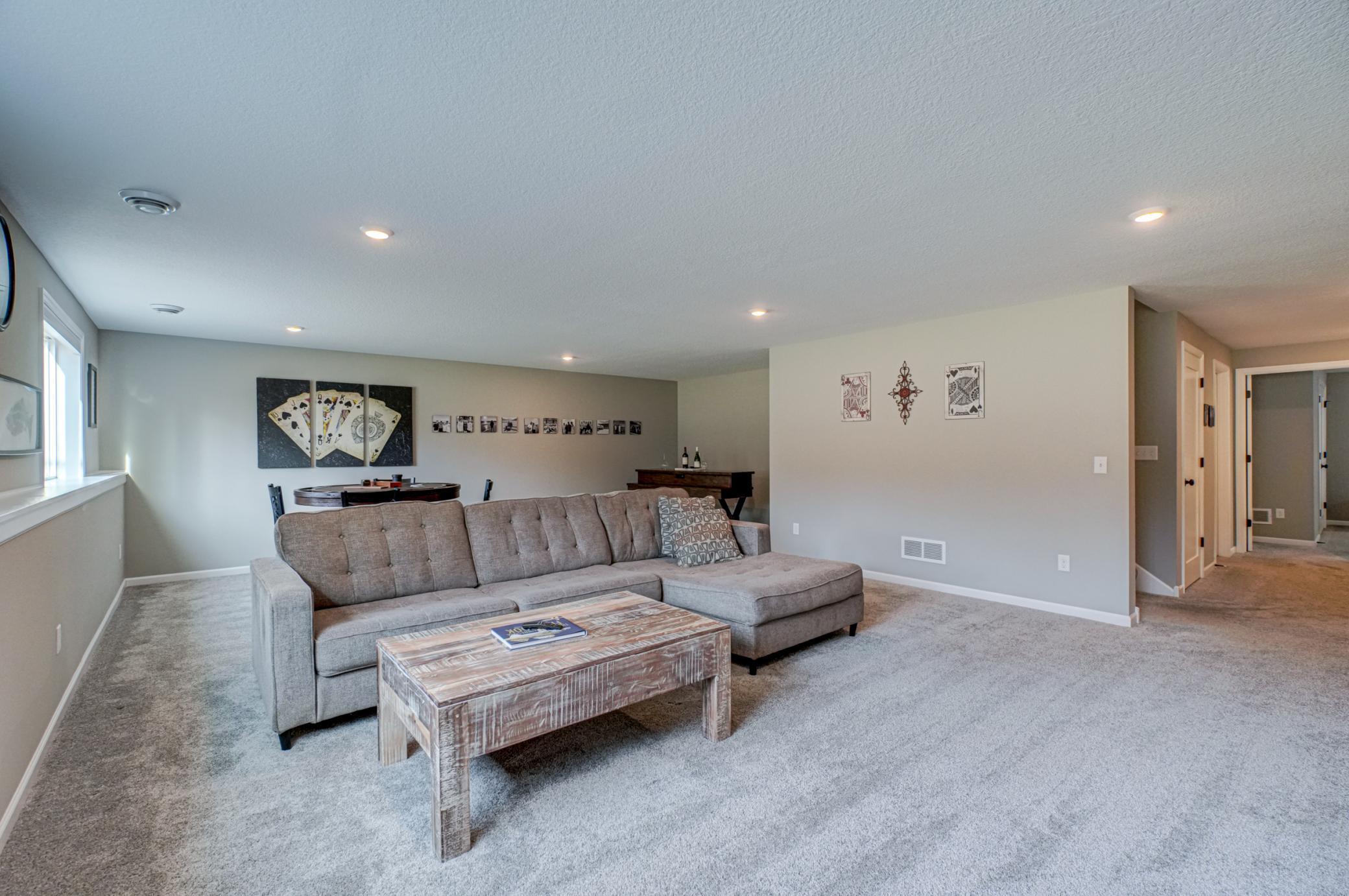 The finished lower level offers a large living and entertaining space, additional bedrooms, and incredible storage.