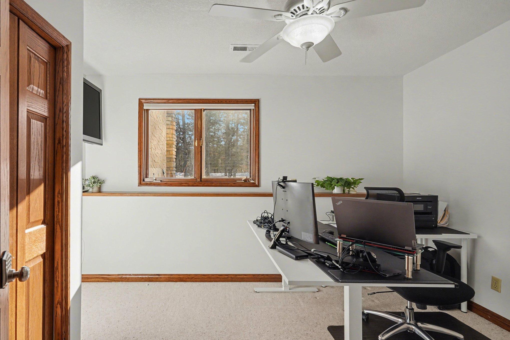 This charming fourth bedroom offers a single closet, a ceiling fan, and a large window with beautiful views of the mature trees in the front yard. A quiet, private space for family or guests!