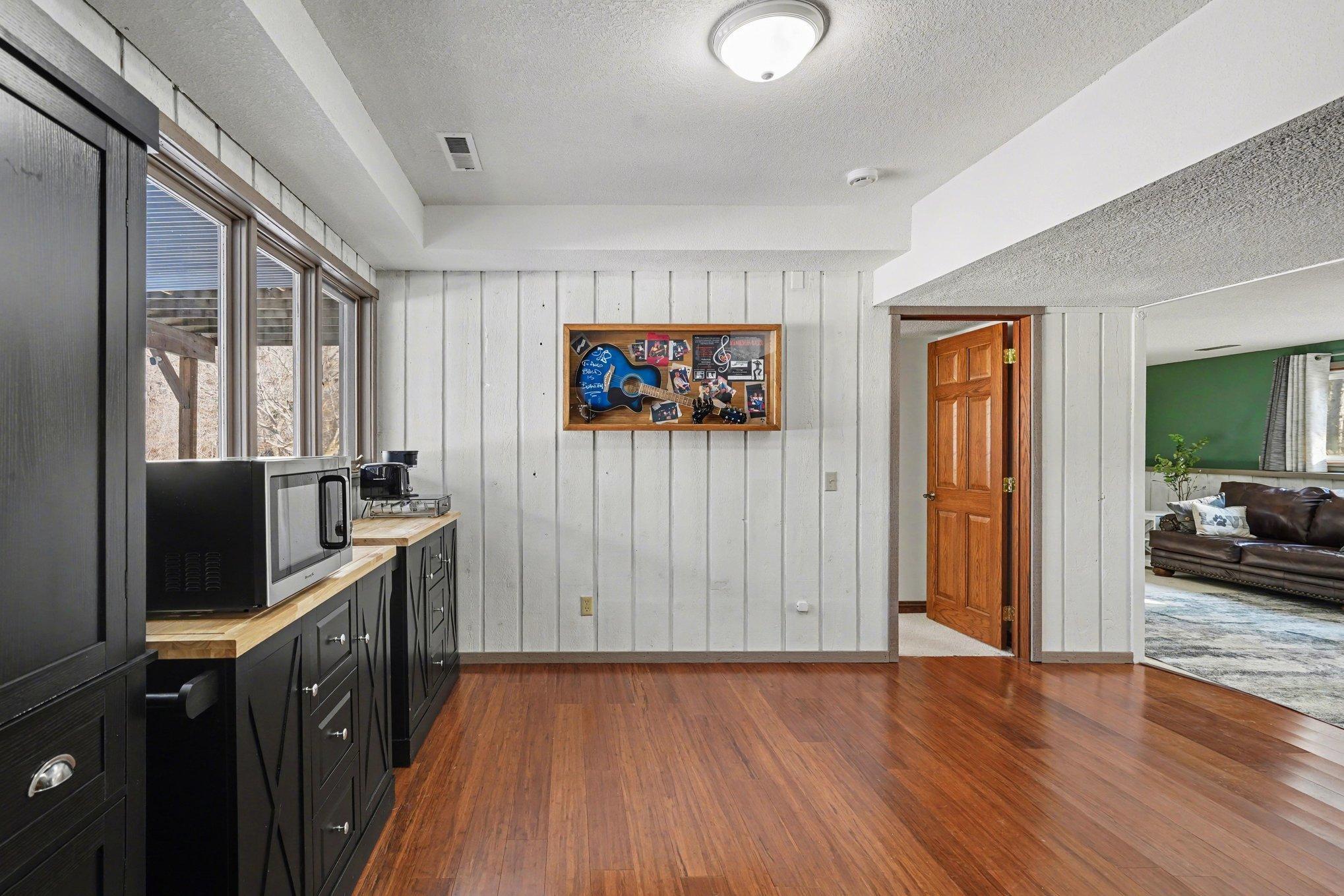 This bonus entertaining wing, a storage closet, and three sun-drenched windows. Step outside via the private access door to a dry, covered patio area tucked neatly under the upper deck!