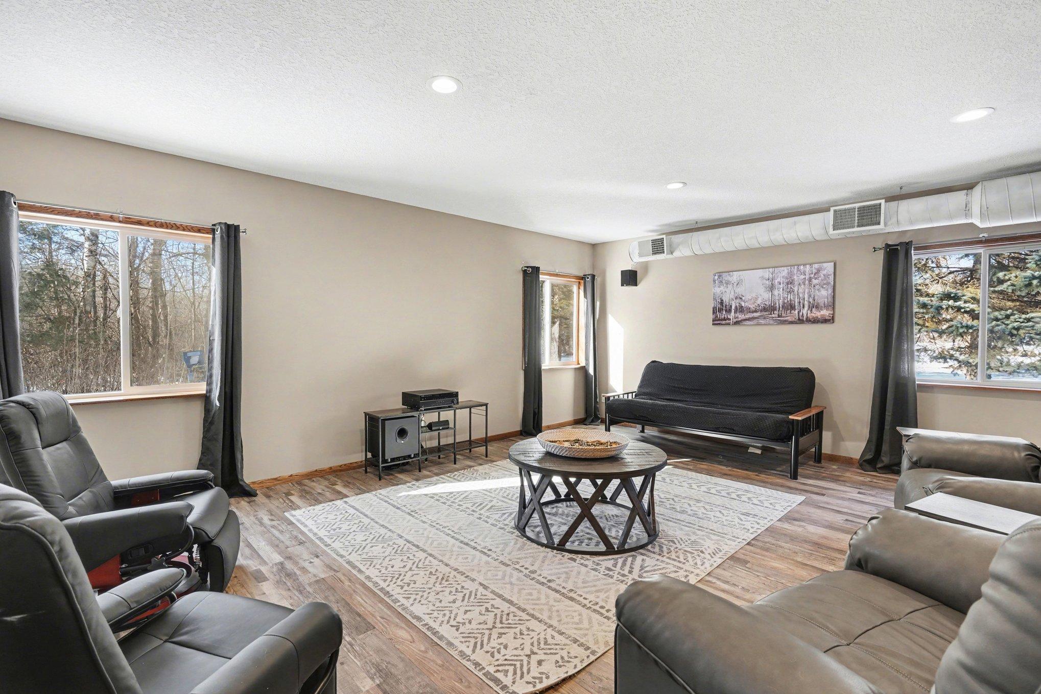 The place to be on game day! Features include dedicated heat/AC, 100-amp electrical service, a massive projection TV, and a full surround-sound system (stays with the home!). Experience the ultimate shop & entertainment retreat in style!
