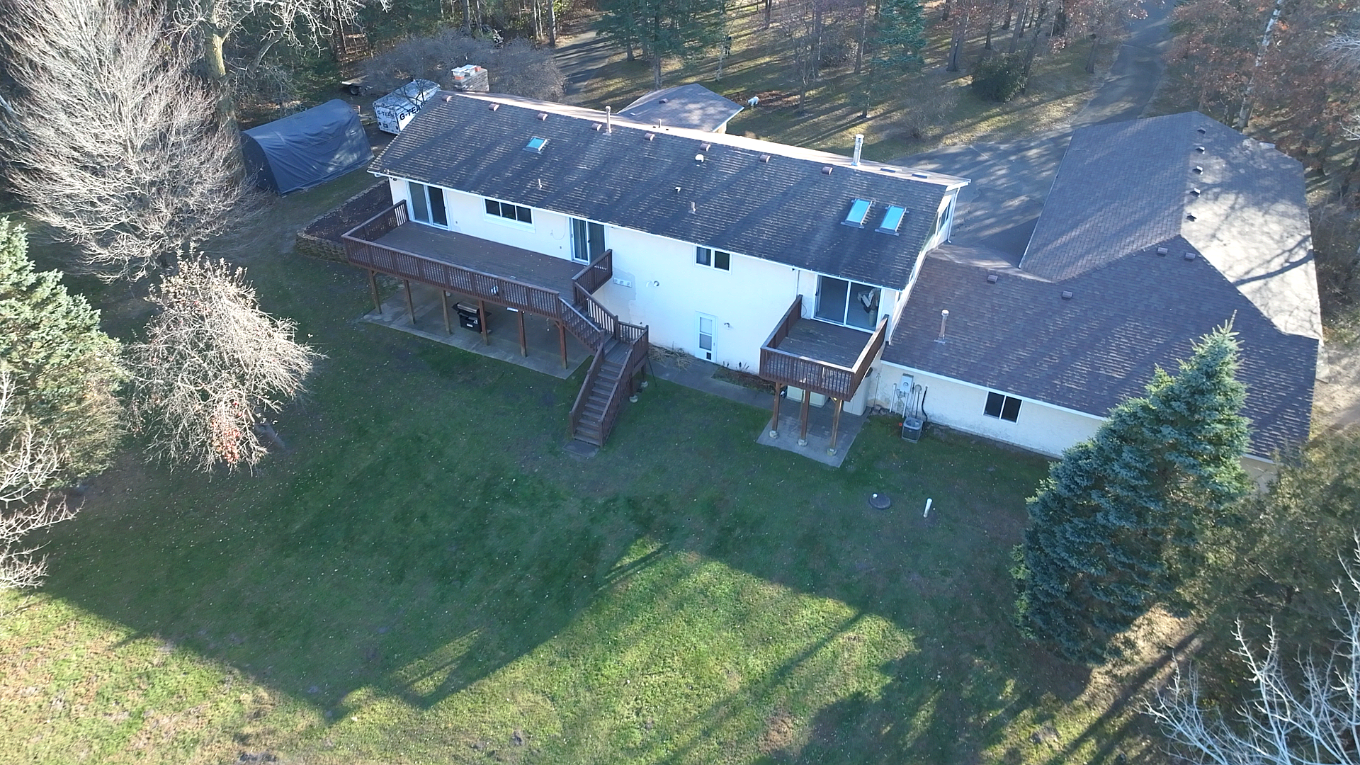 Another aerial view of the home and the private wooded lot.