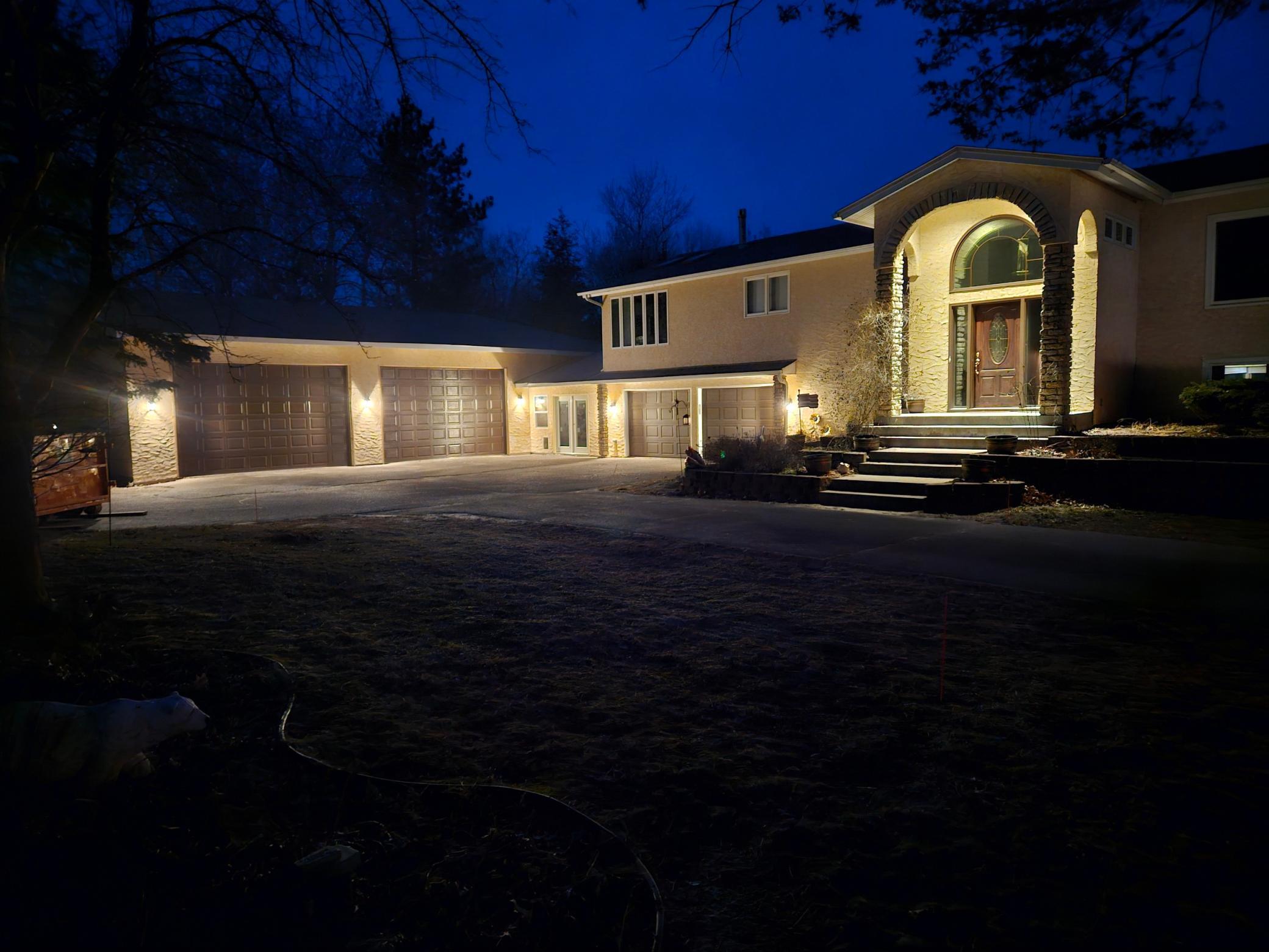 Twilight view of the home shows off it's beauty and size.