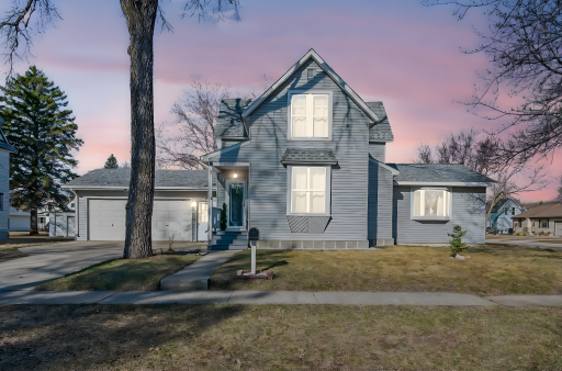 Charming front exterior w/ welcoming entry and attached garage