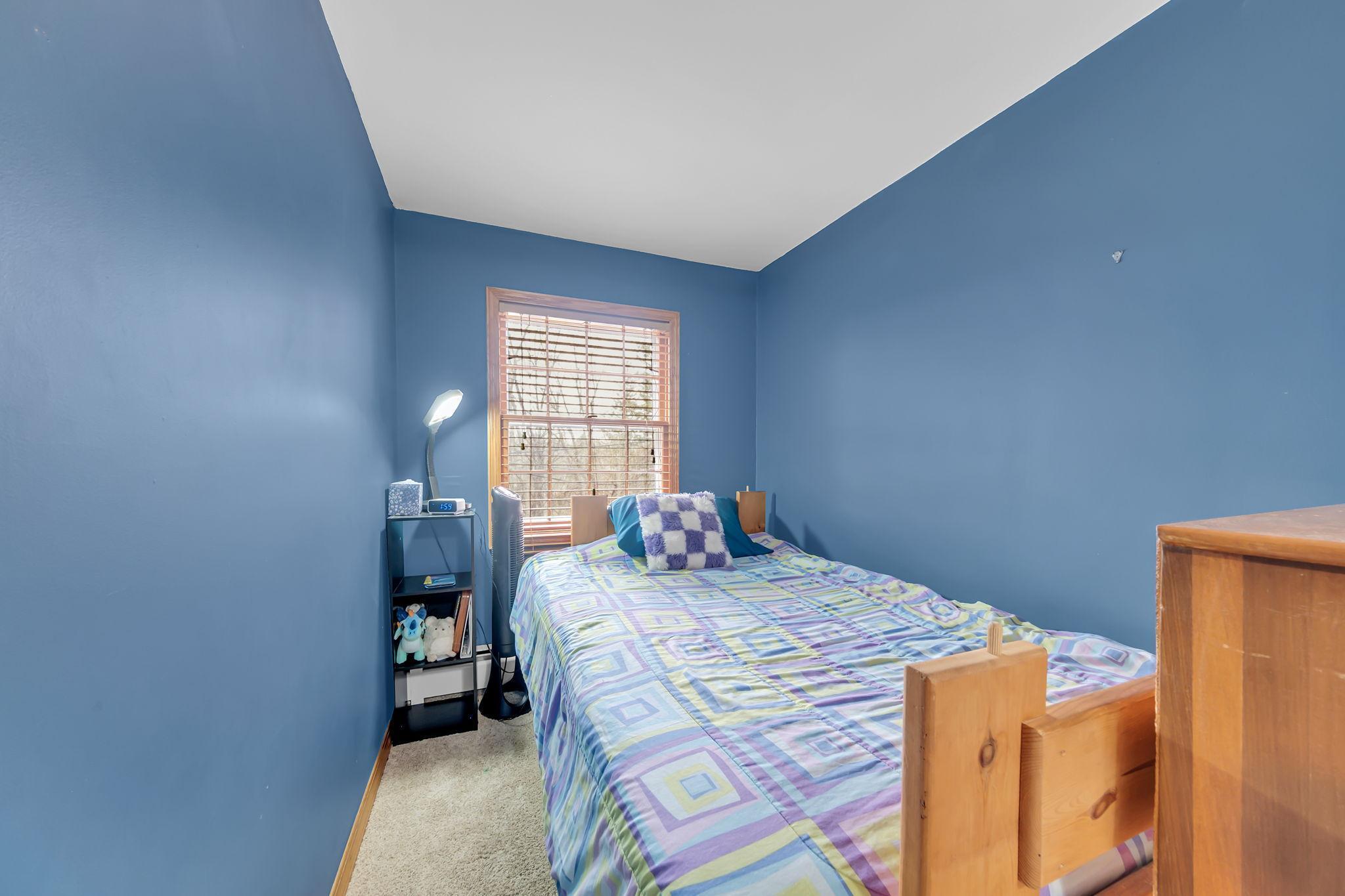 Nook inside bedroom that can be used as a reading area, or room for an extra bed, as shown.