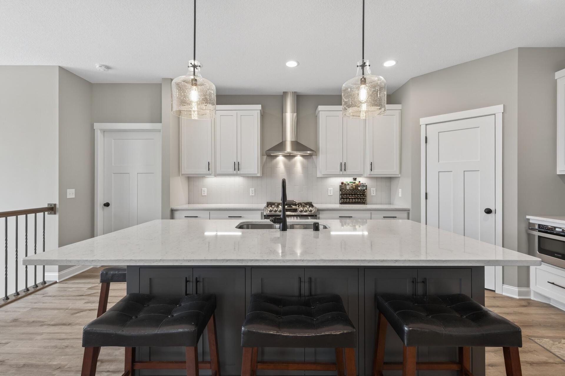 Kitchen offers quartz countertops, stainless steel appliances and custom built cabinetry!
