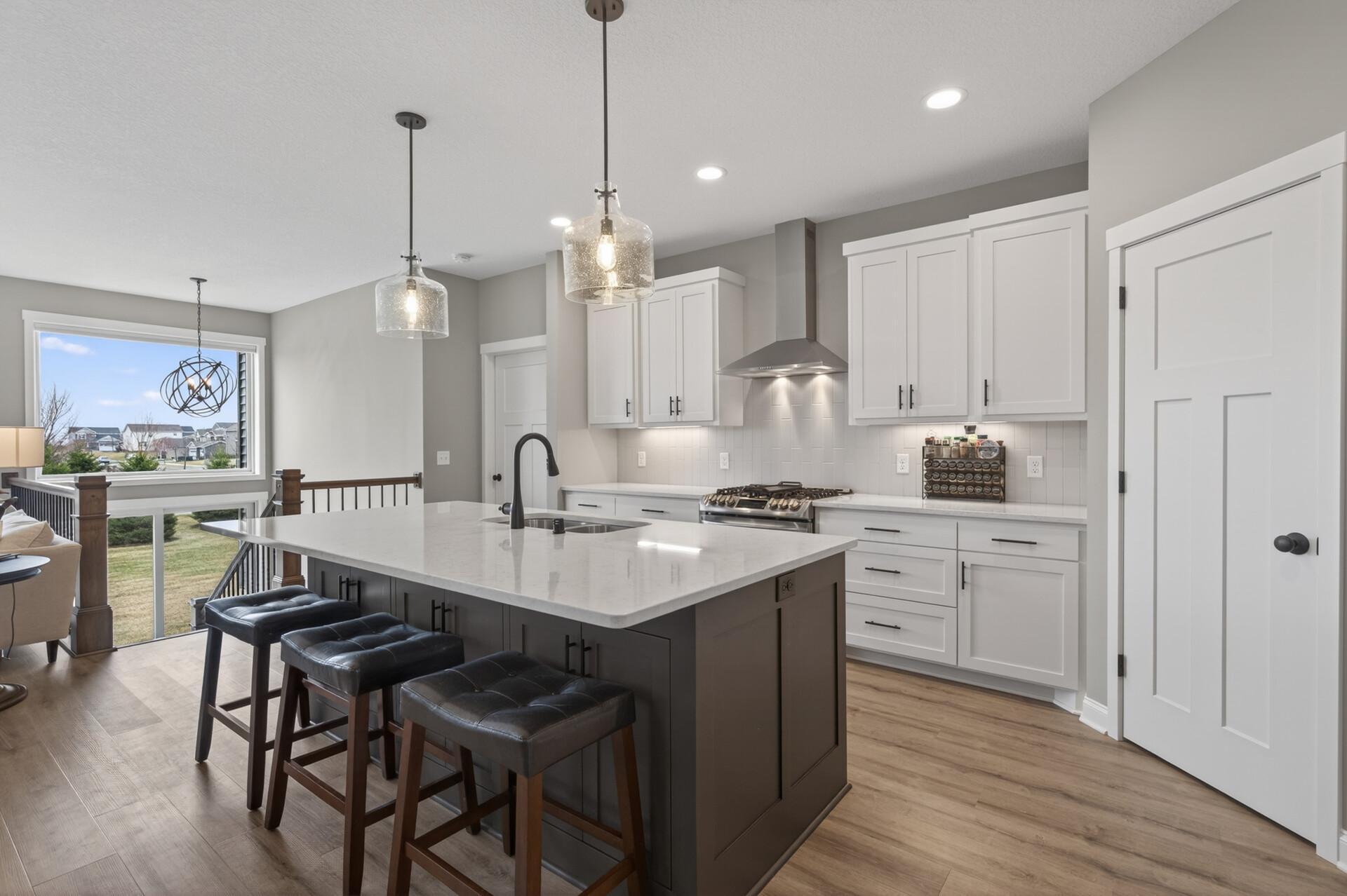 Kitchen offers quartz countertops, stainless steel appliances and custom built cabinetry!