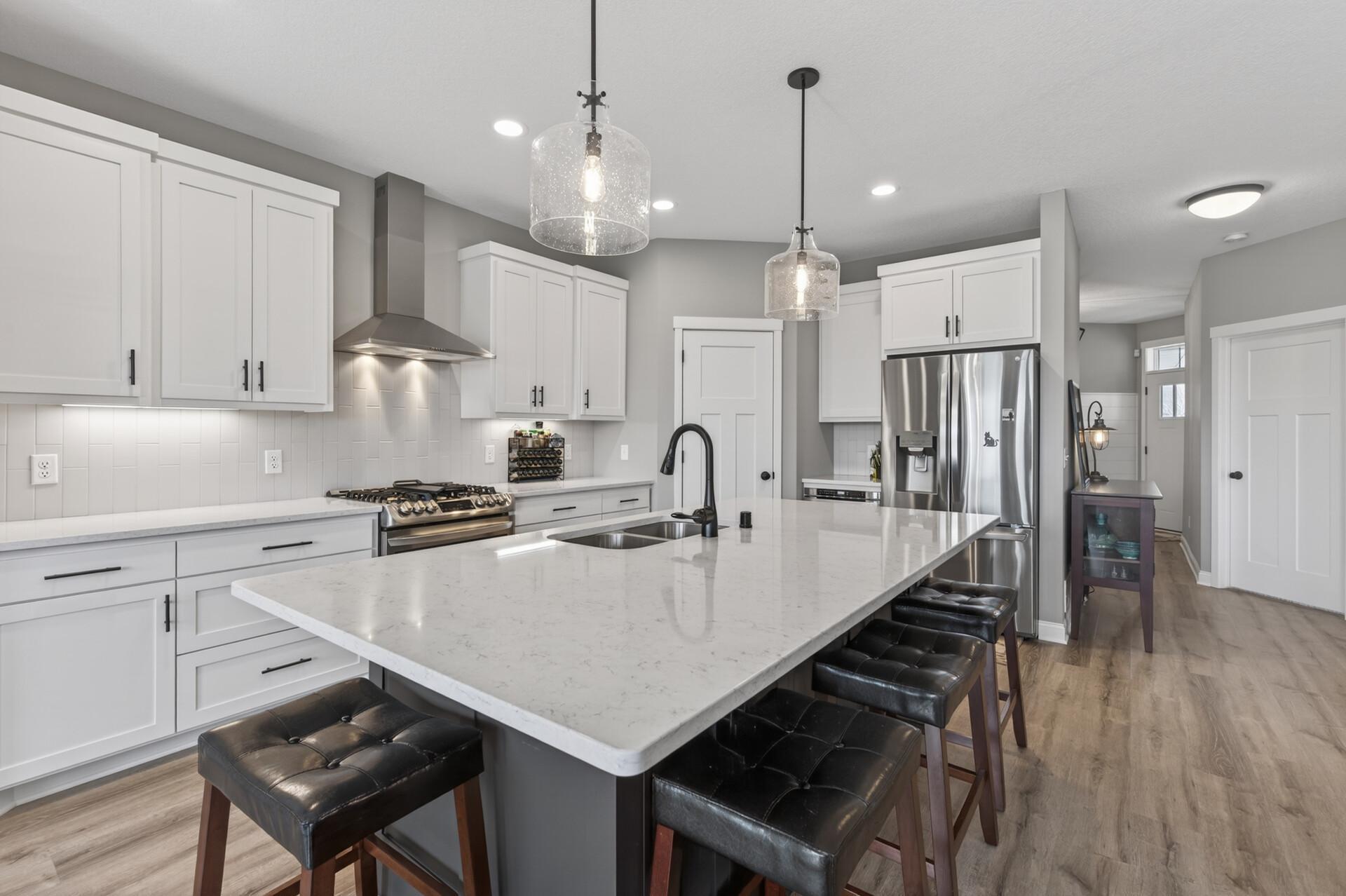 Kitchen offers quartz countertops, stainless steel appliances and custom built cabinetry!