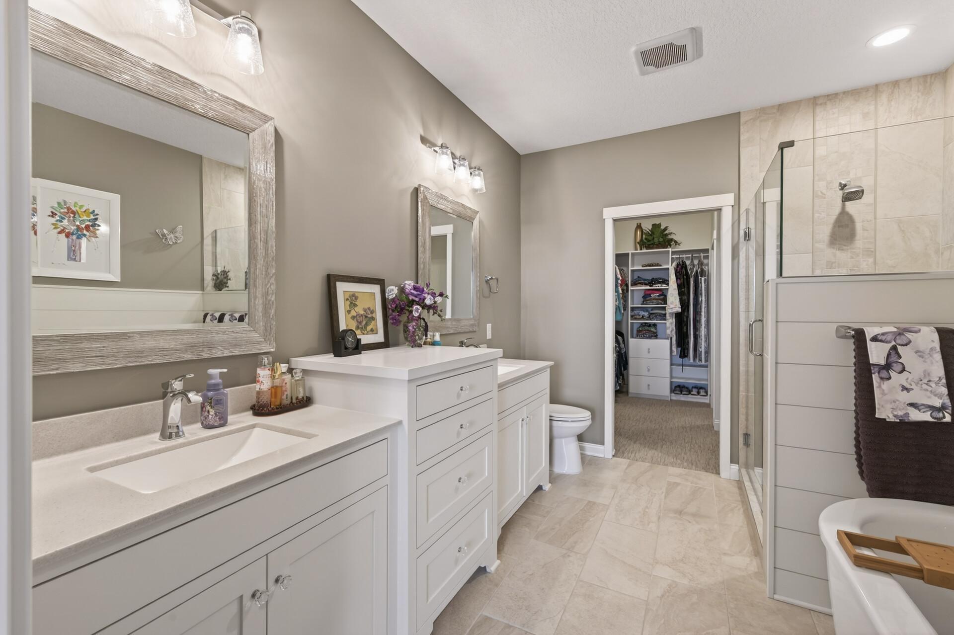 Primary bathroom with double sink, soaking tub, and fully tiled walk-in shower!