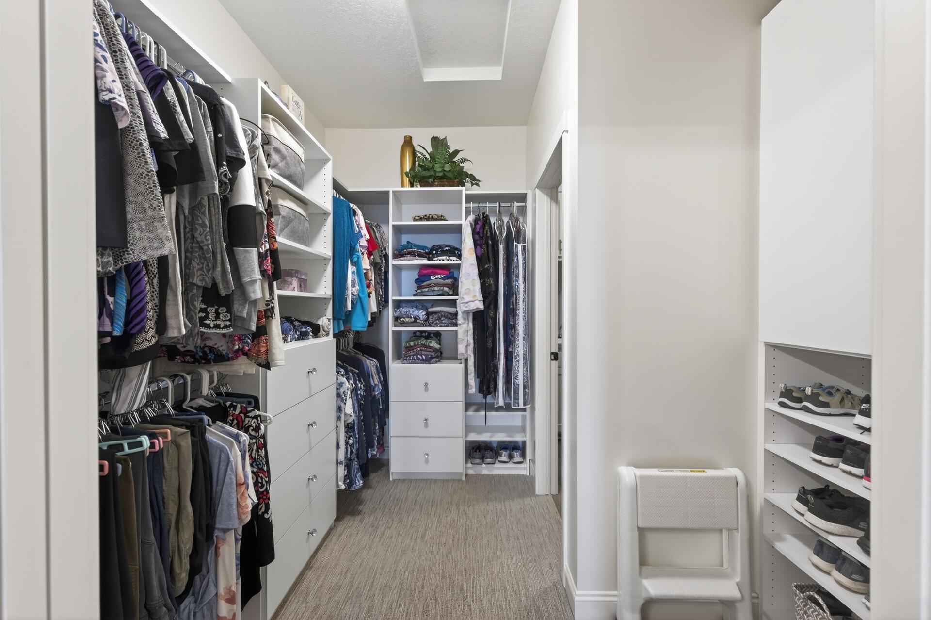 Primary bedroom walk-in closet with upgraded shelving
