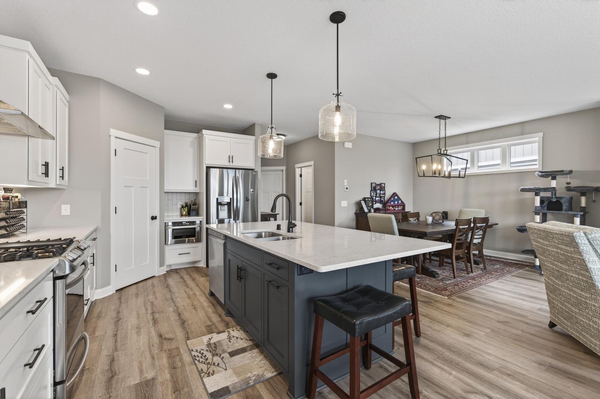 Kitchen offers quartz countertops, stainless steel appliances and custom built cabinetry!