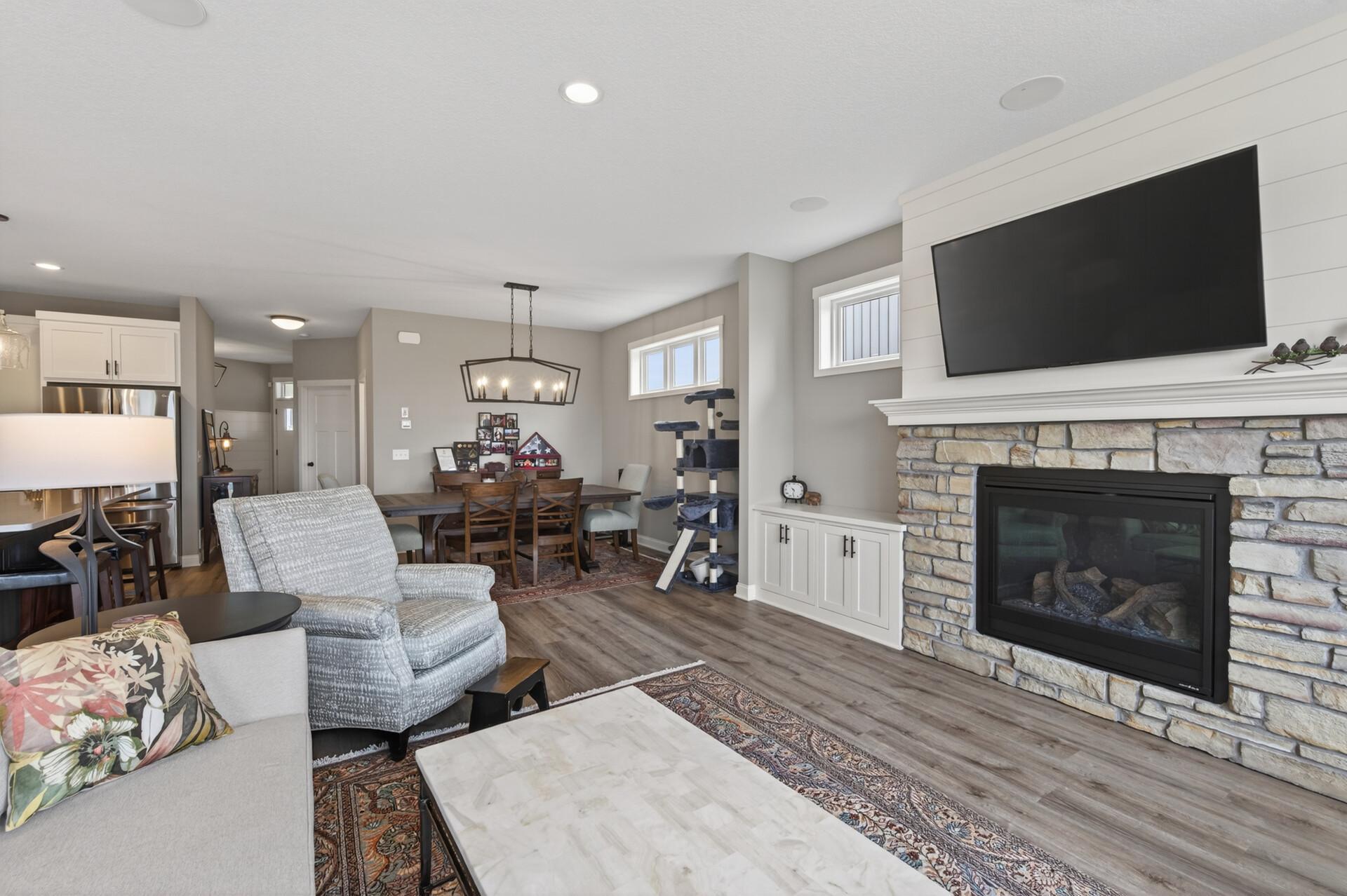 Living room with views into the dining room. Lovely built-ins accent the stone fireplace beautifully!