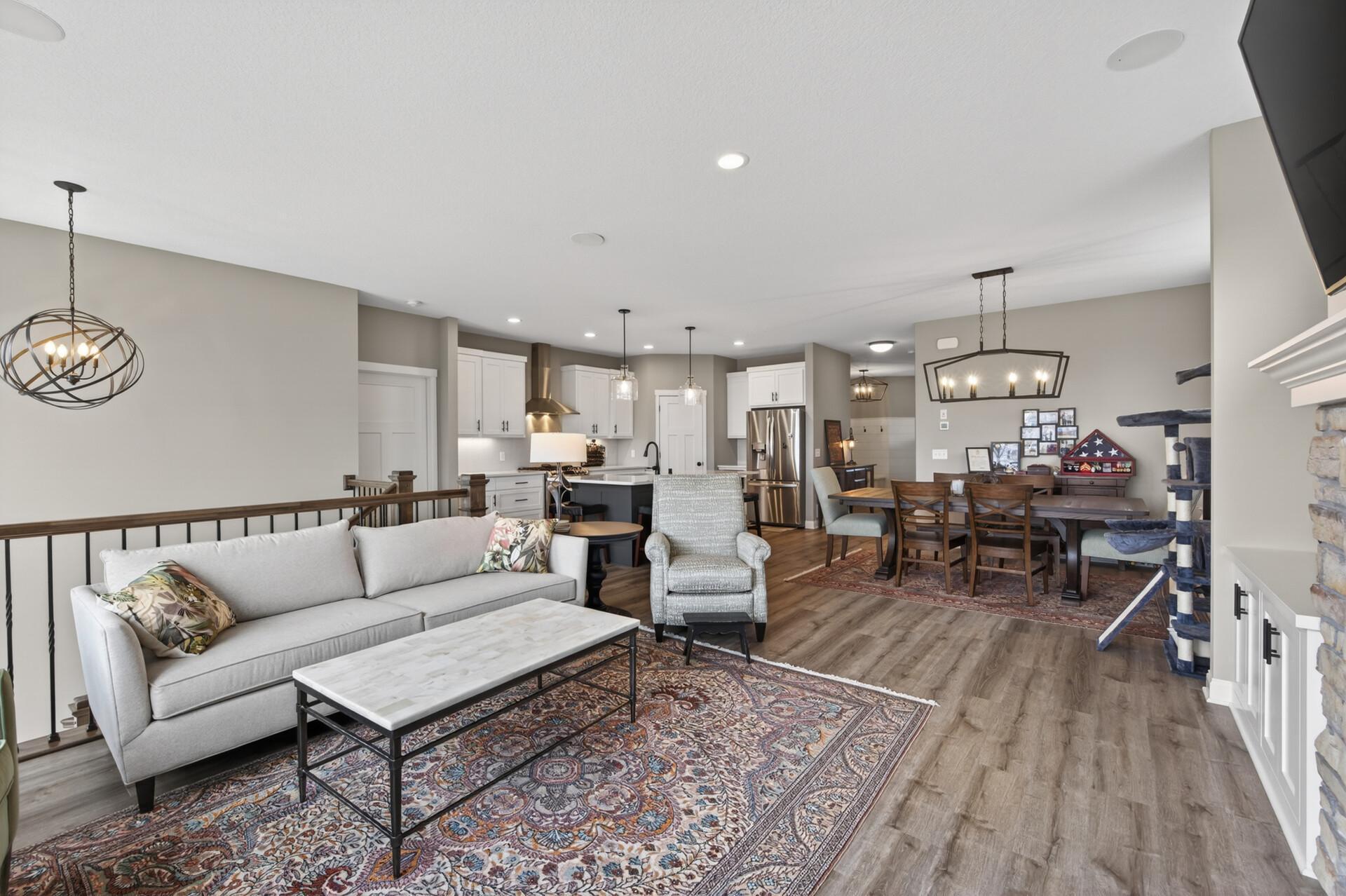 Living room with views into the kitchen and dining room areas