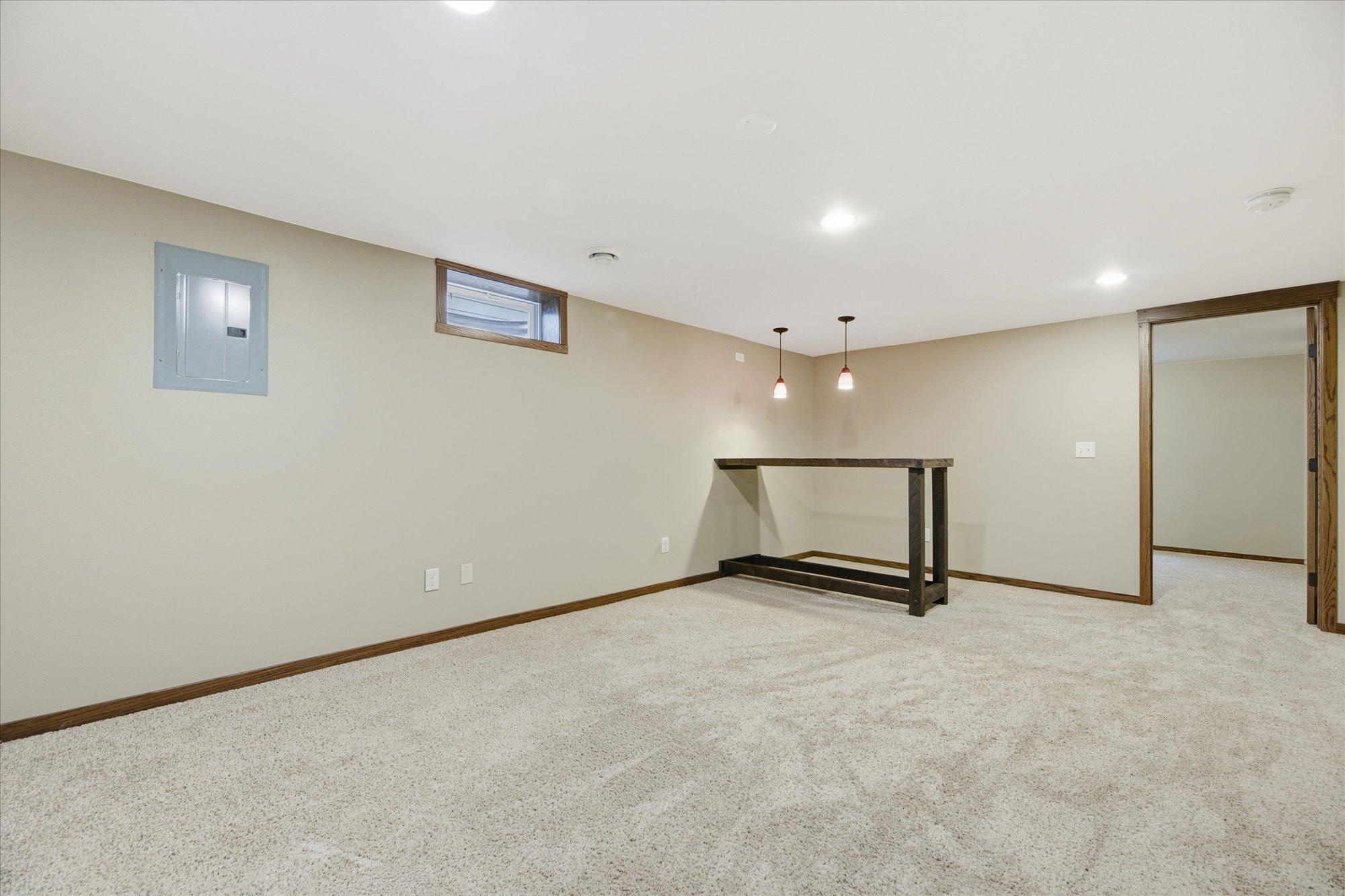 Finished lower-level with family room and bar area—great for entertaining.