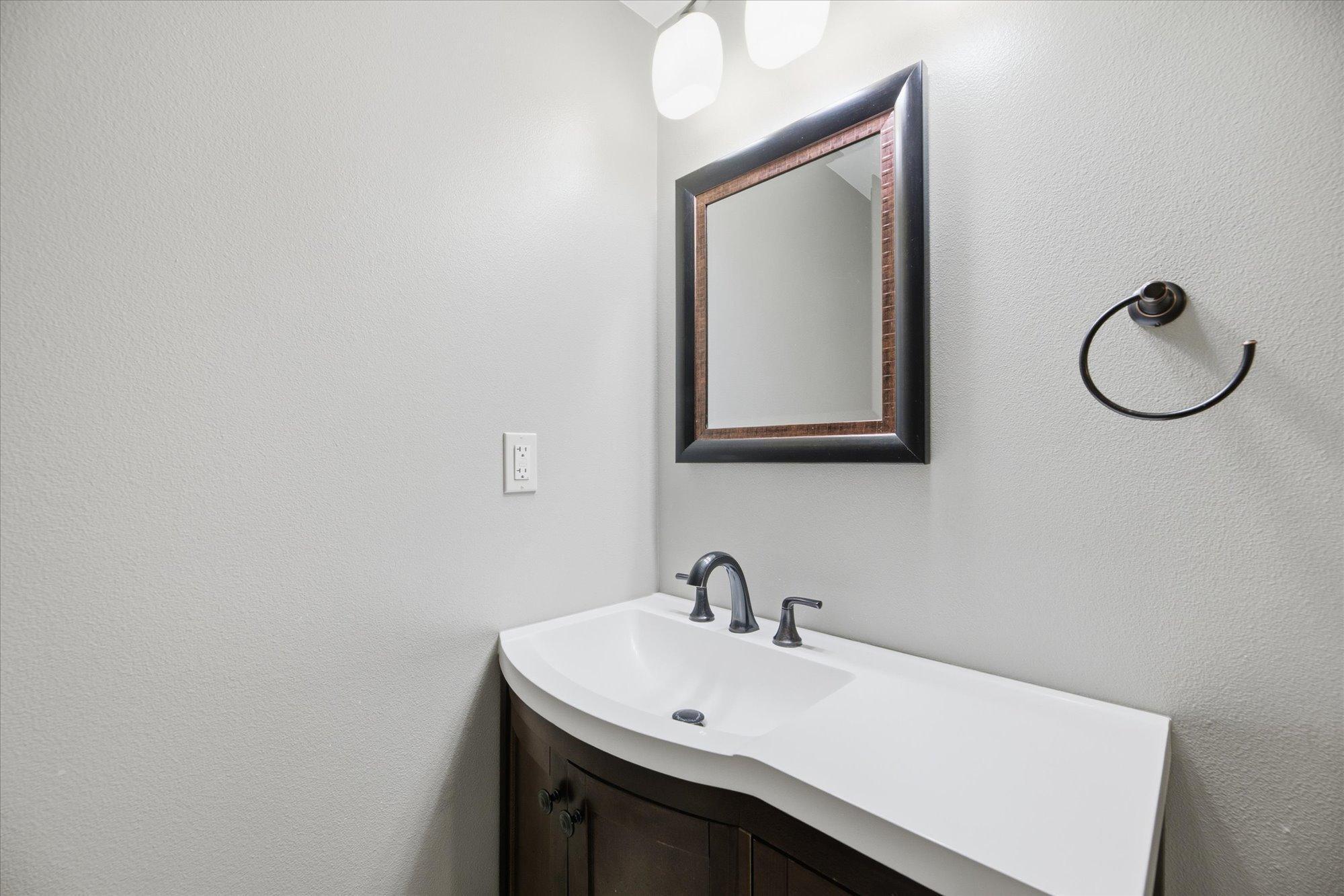 Lower-level bathroom vanity area featuring a modern sink, updated fixtures, and a clean, contemporary look.