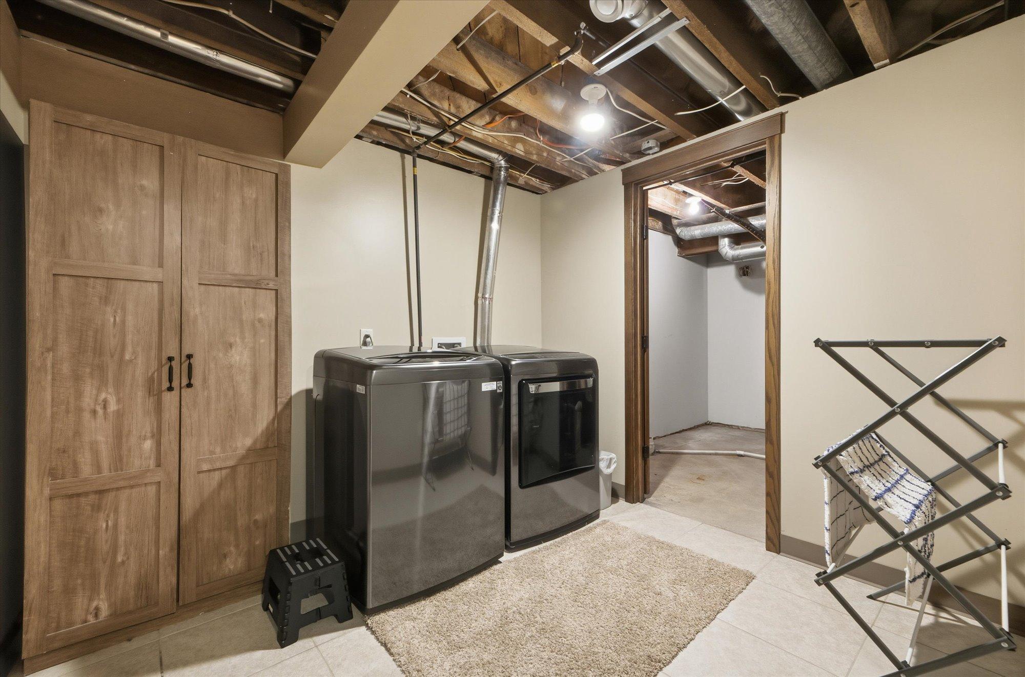 Spacious laundry area with newer washer and dryer, and extra room for storage or organization.