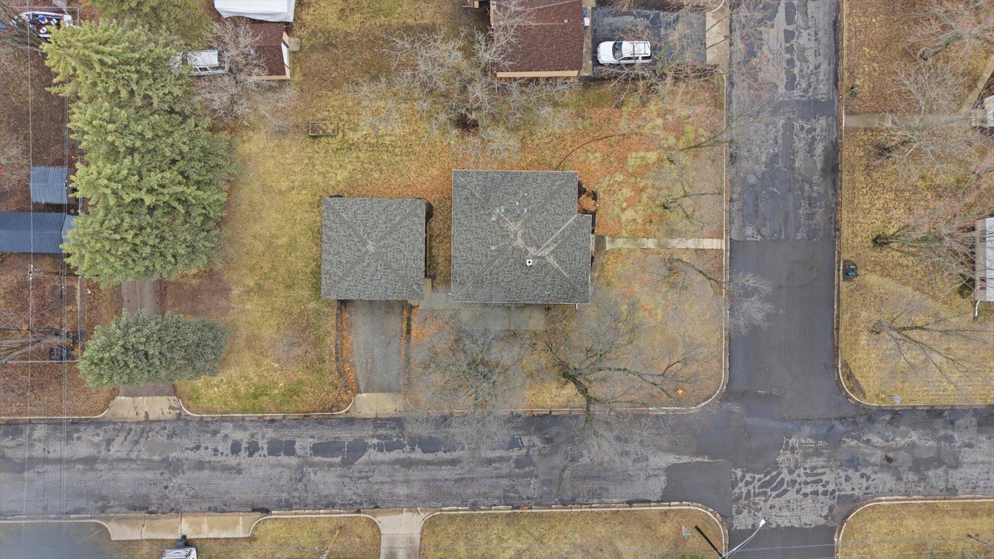 Aerial perspective showcasing the expansive corner lot with mature trees and a great overall footprint.