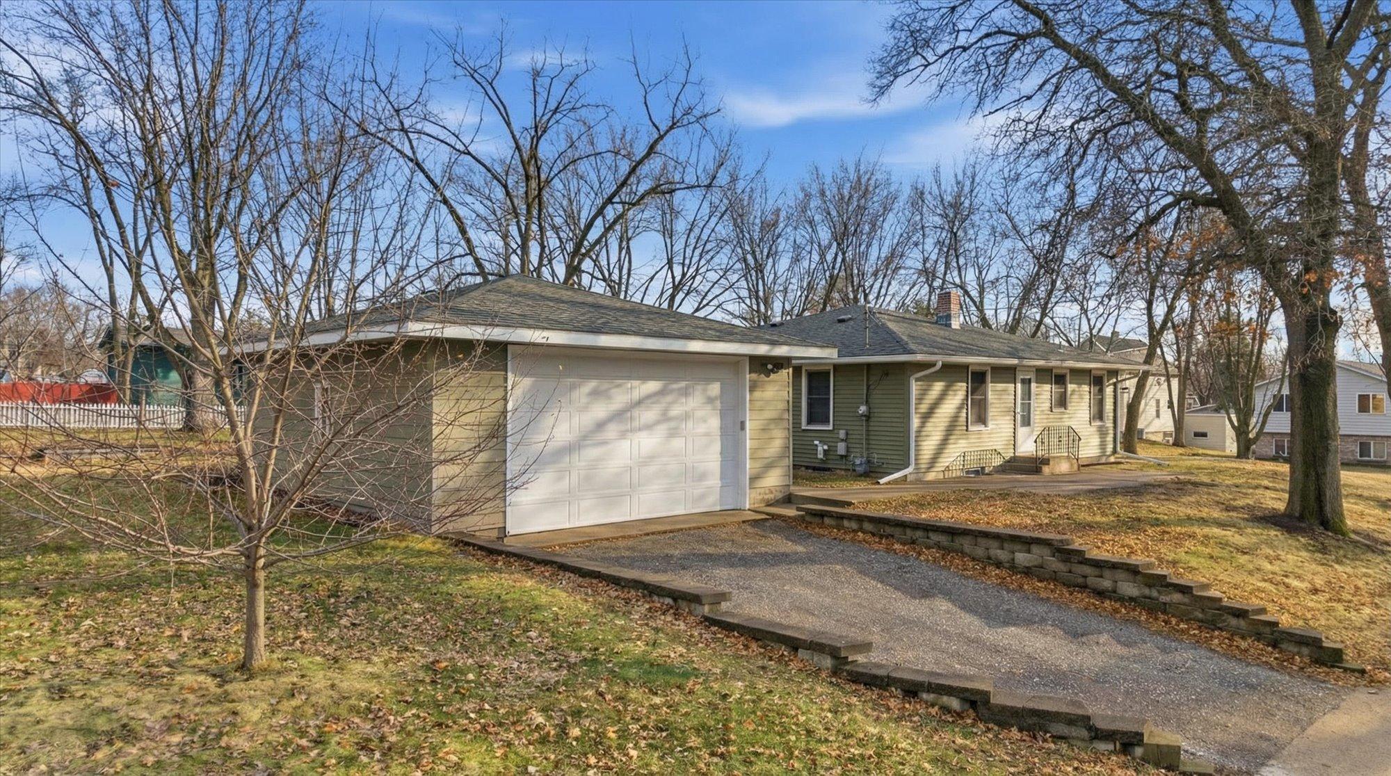 Two-car garage offering plenty of room for vehicles, storage, and workspace, plus an extended driveway for additional parking.