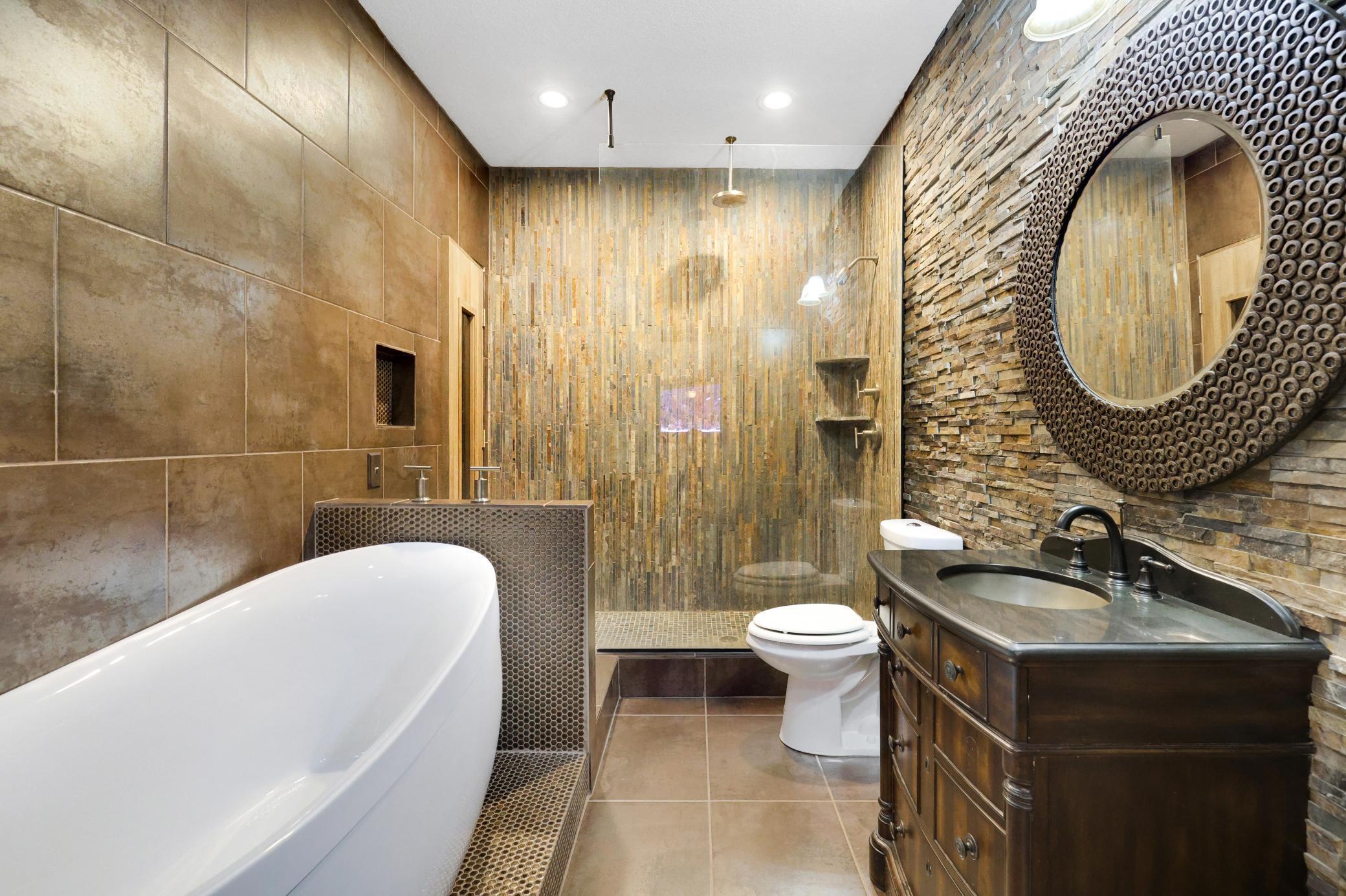 Gorgeous custom bathroom on the lower level just steps away from the theatre room.