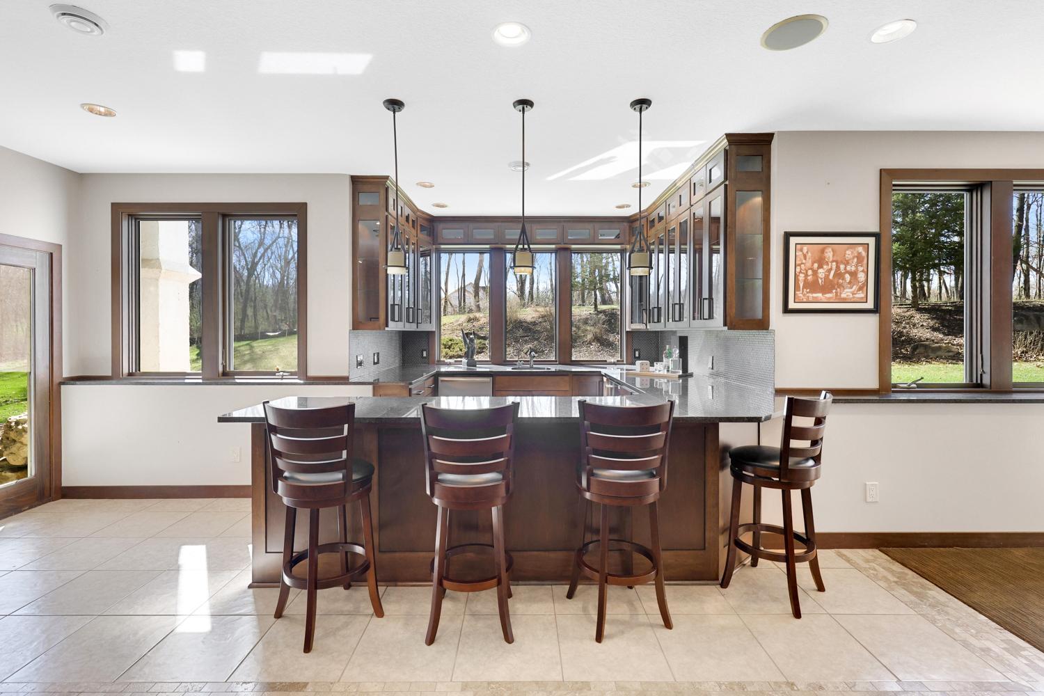 Lower level bar with plenty of cabinets, fridge and dishwasher. Makes entertaining effortless.