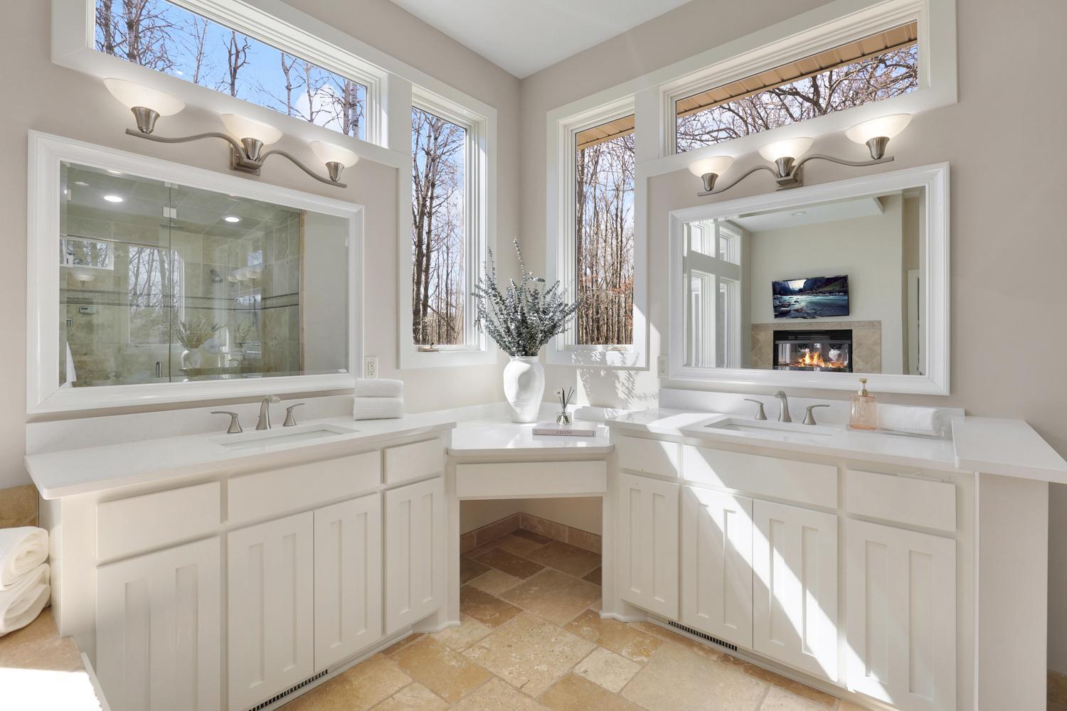 The primary bath, with large double vanities, also features a walk-in steam shower, perfect for destressing.