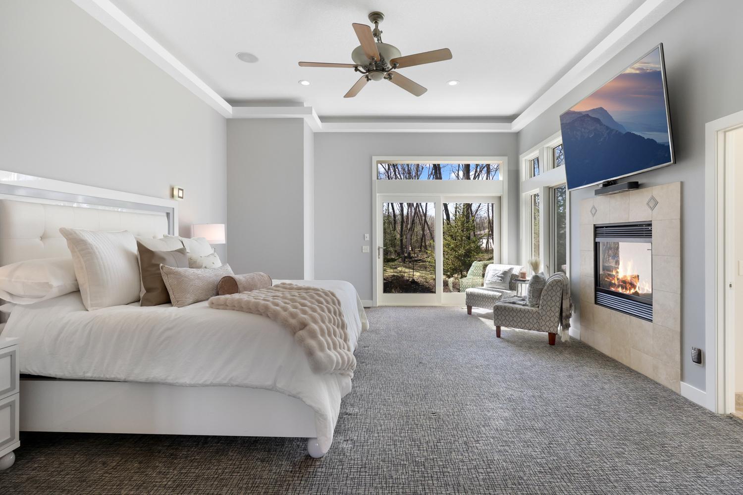 The primary suite invokes feelings of a spa retreat surrounded by nature.