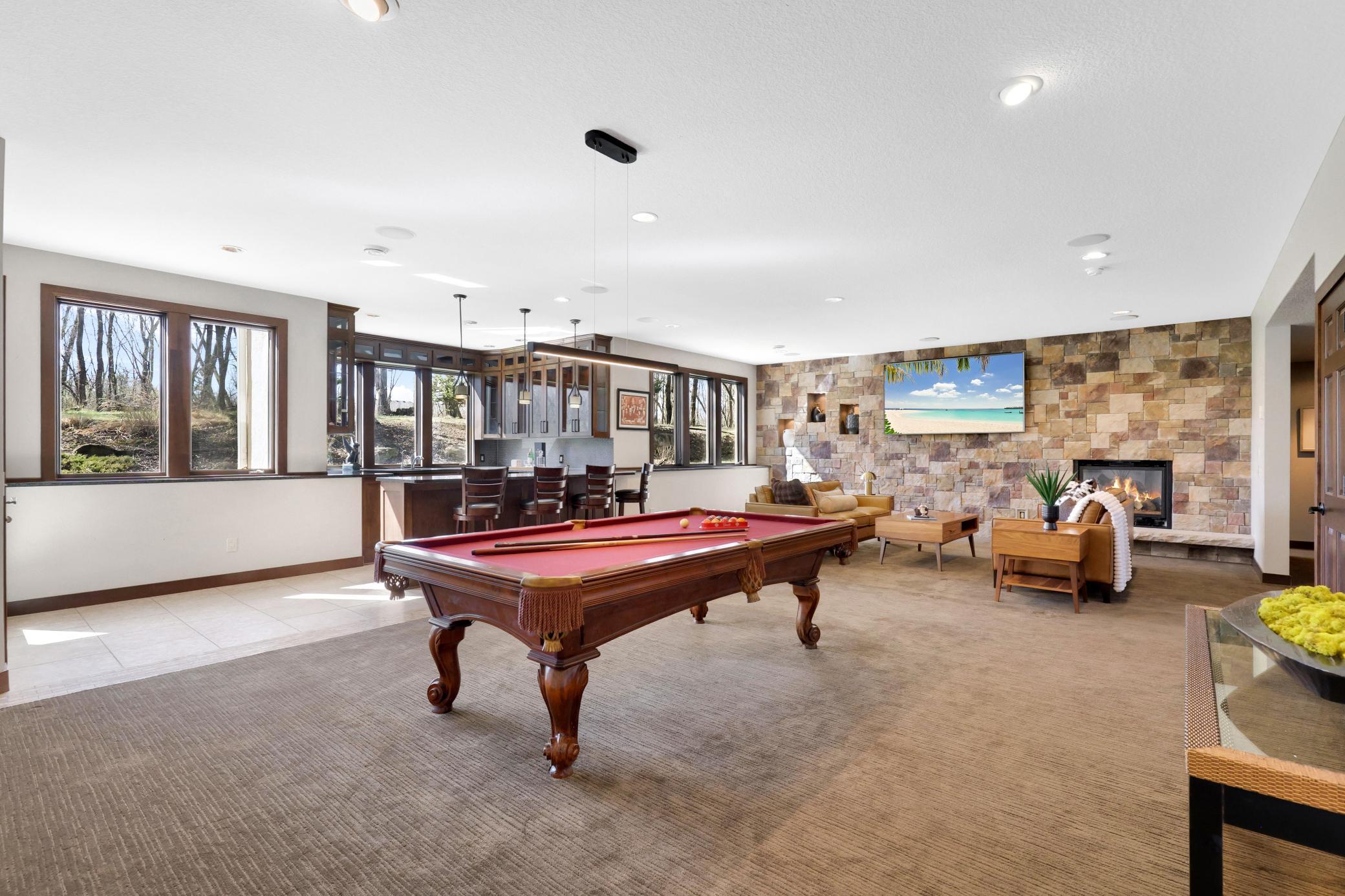 Meet the impressive lower level with 10ft ceilings, game table and expansive walk-around bar.