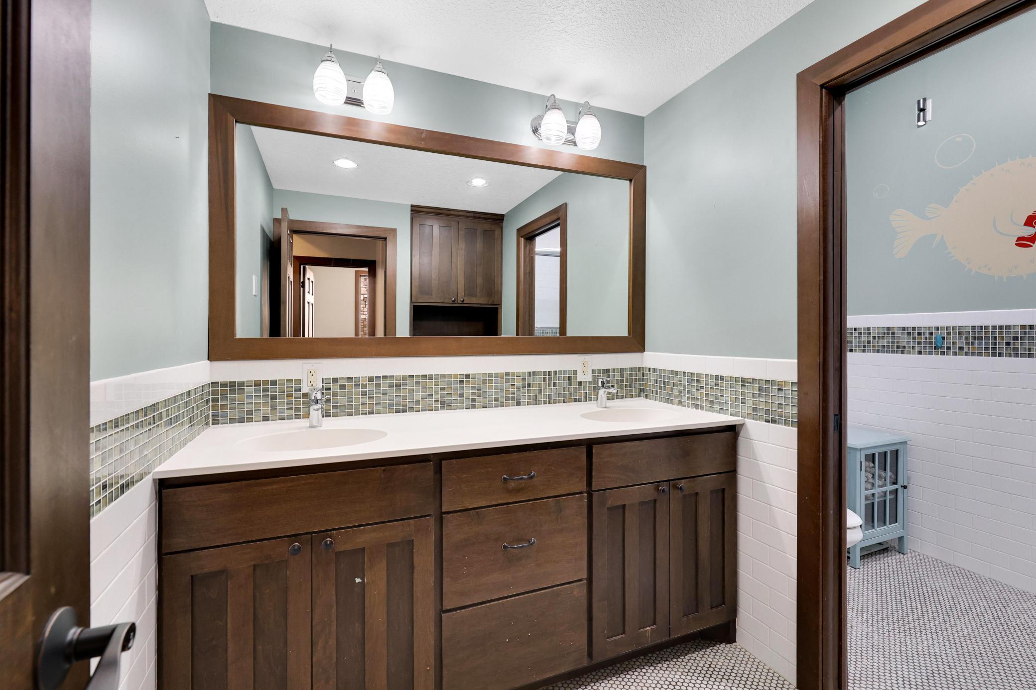 Lower level bath located outside two of the bedrooms.