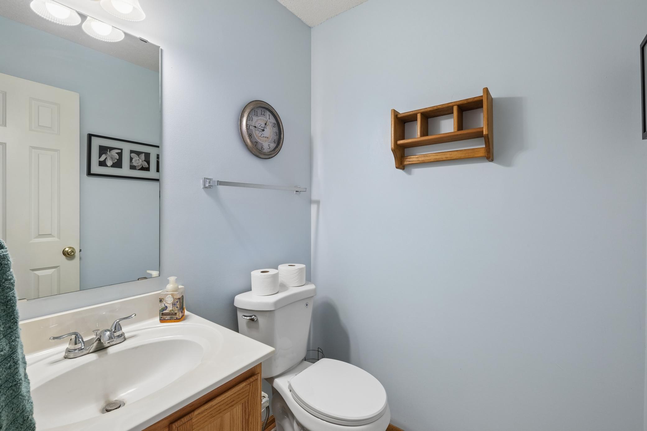 Main floor powder bath with new flooring and toilet.