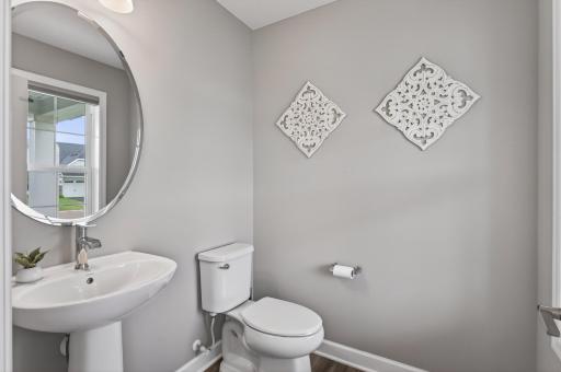 Convenient main-level guest bath tucked just off the entry.