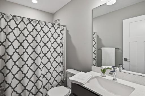 A full upper-level bathroom with modern finishes and plenty of room for busy mornings.