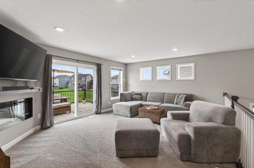 Large windows and sliding doors fill the space with natural light.