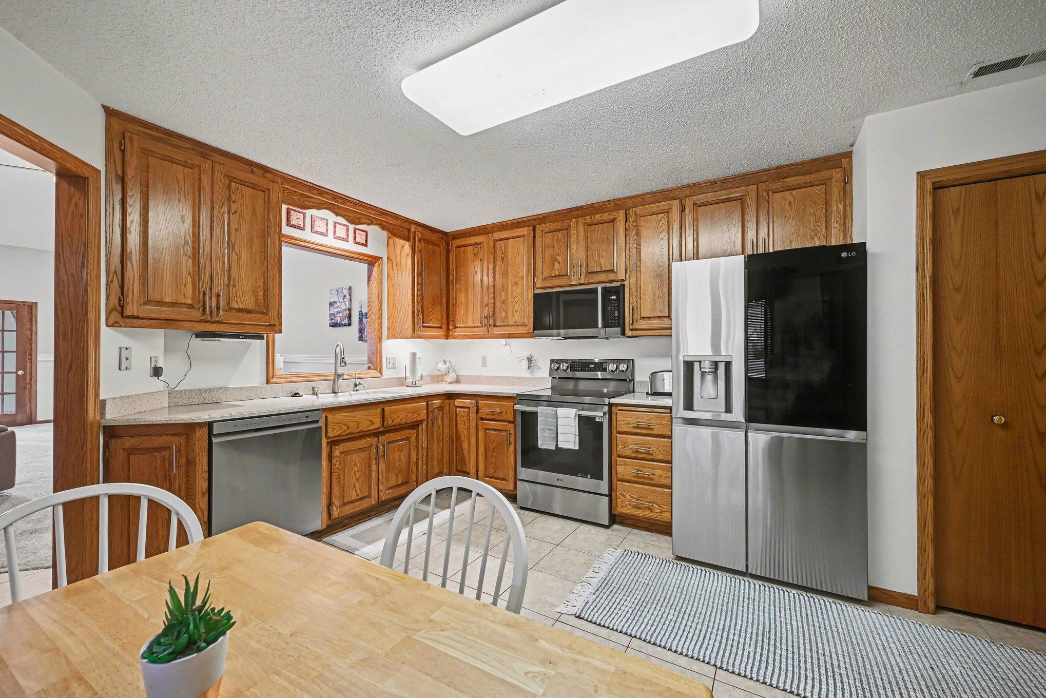 15x14 Kitchen: Tile floors, Stainless appliances, formica countertops