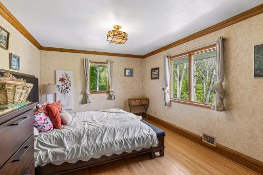 Upper-level bedroom with beautiful hardwood floors.
