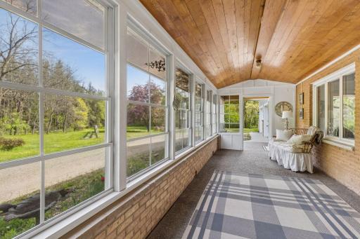 Beautiful woodwork and a cozy feelâthis screen porch is made for slow mornings and relaxed evenings.