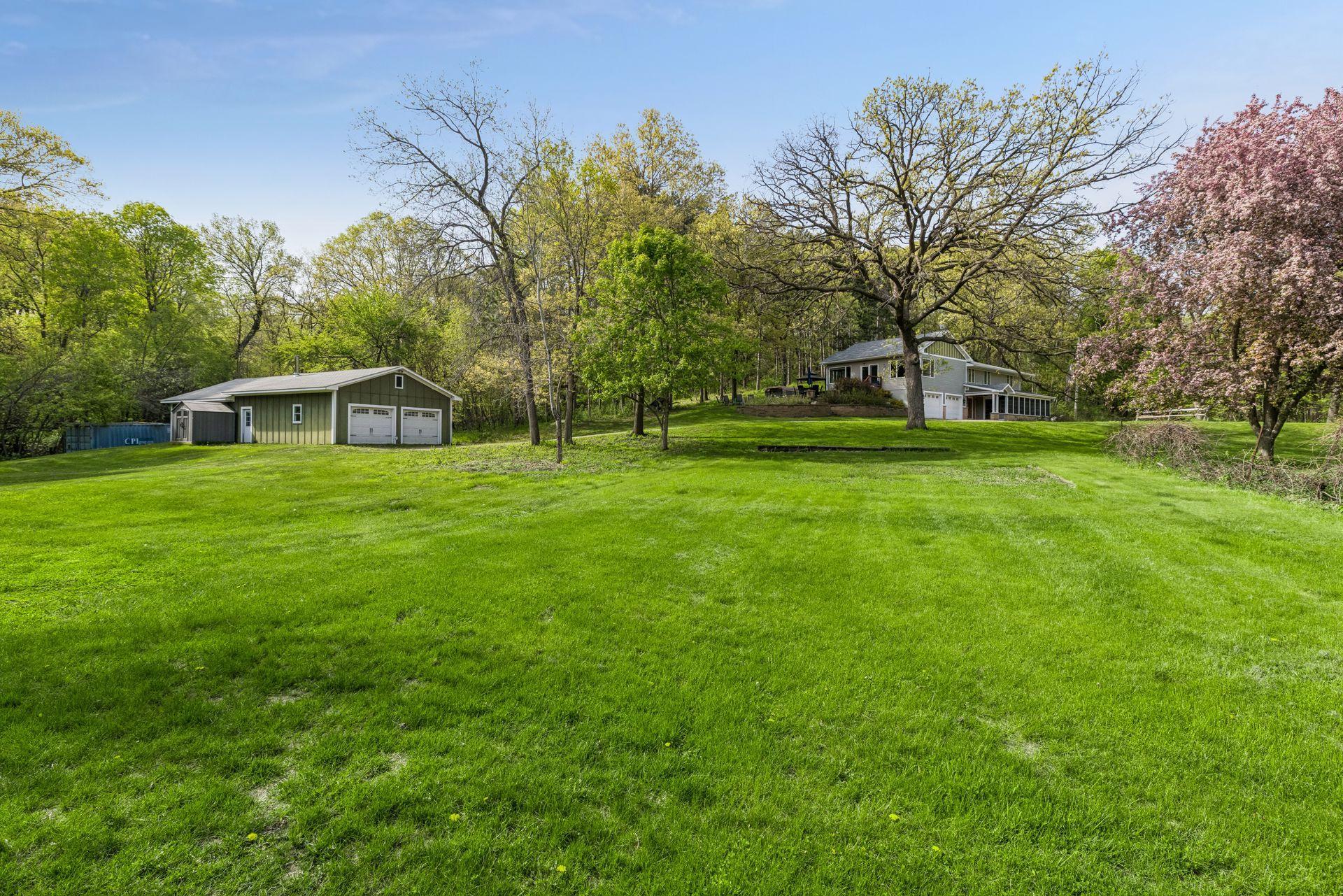 Endless green space surrounds the home and outbuildings, offering room to roam, play, and unwind.