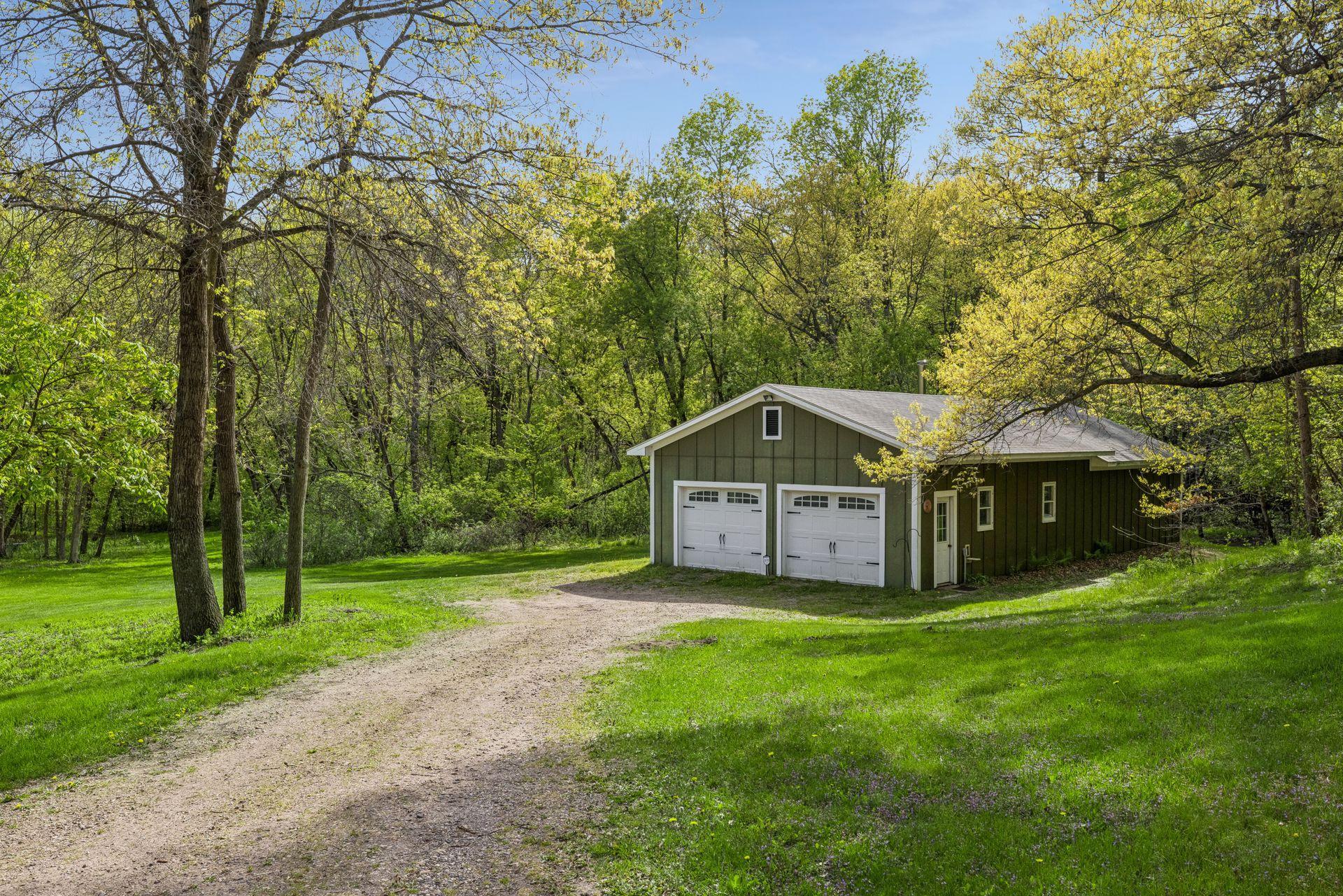 A rare 4-car detached garage with incredible versatility—garage space in front and a finished “man cave” retreat in back.