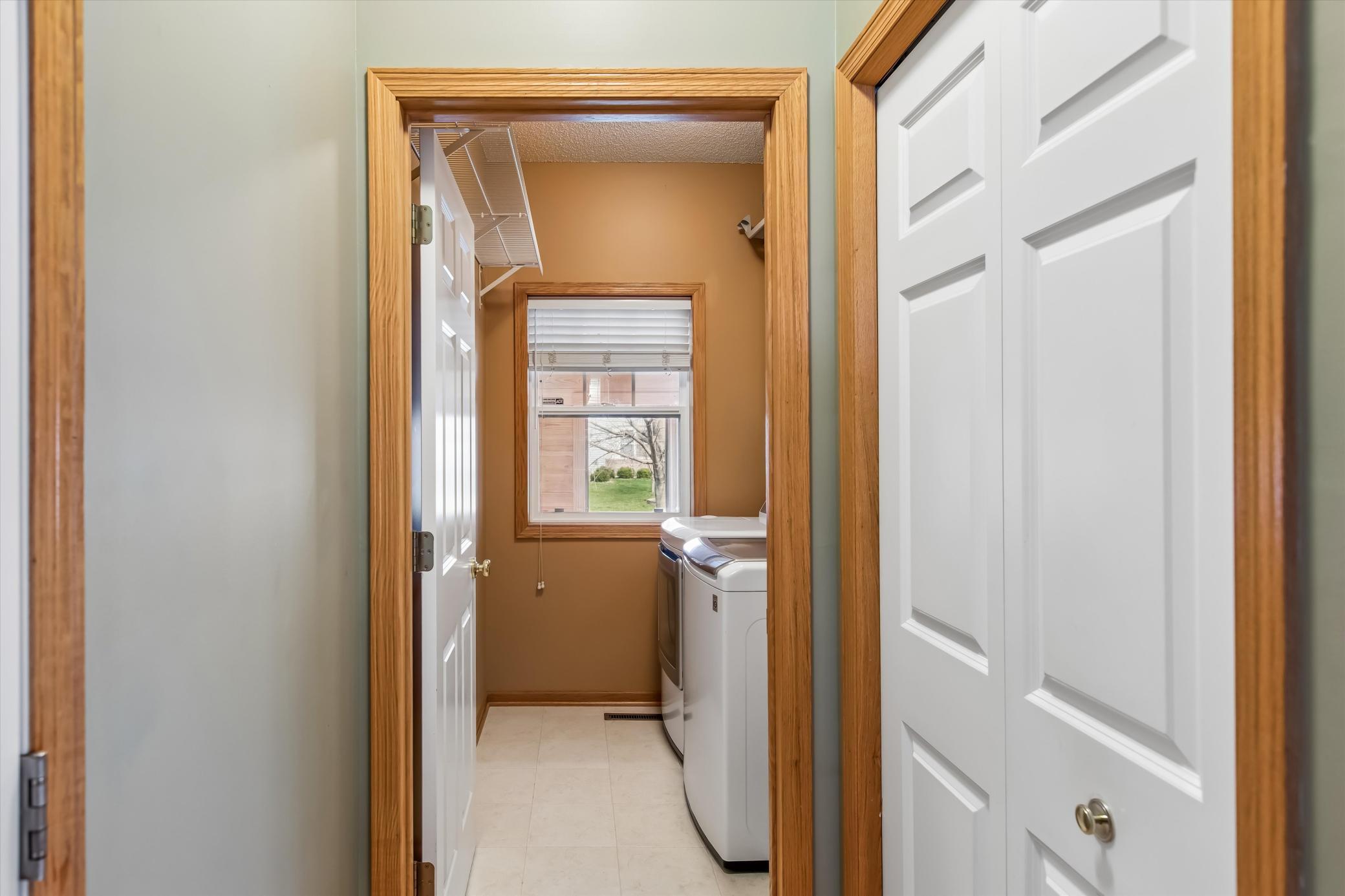 Back hall laundry room with utility sink and shelving