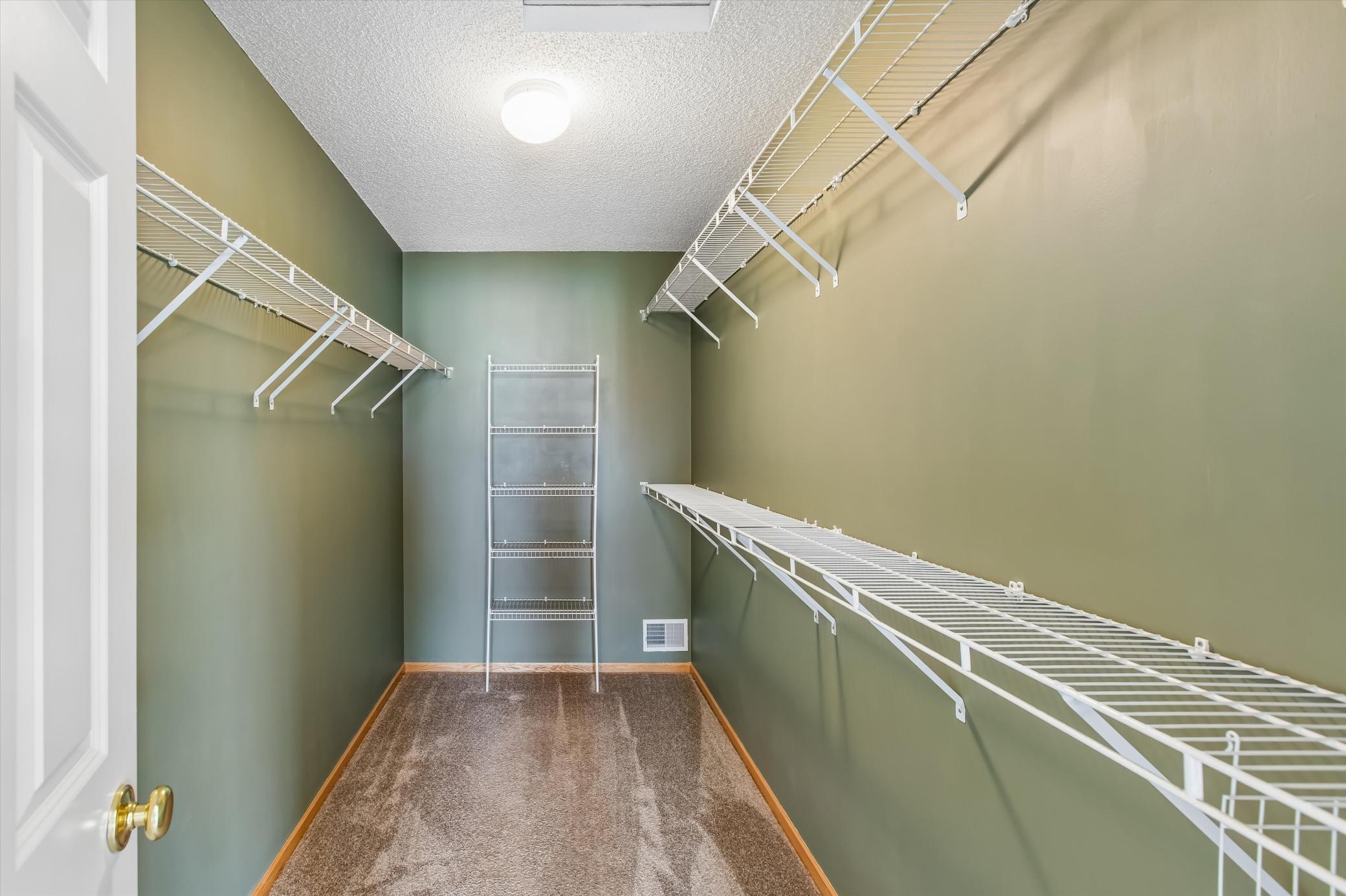 Plenty of storage in primary walk-in closet