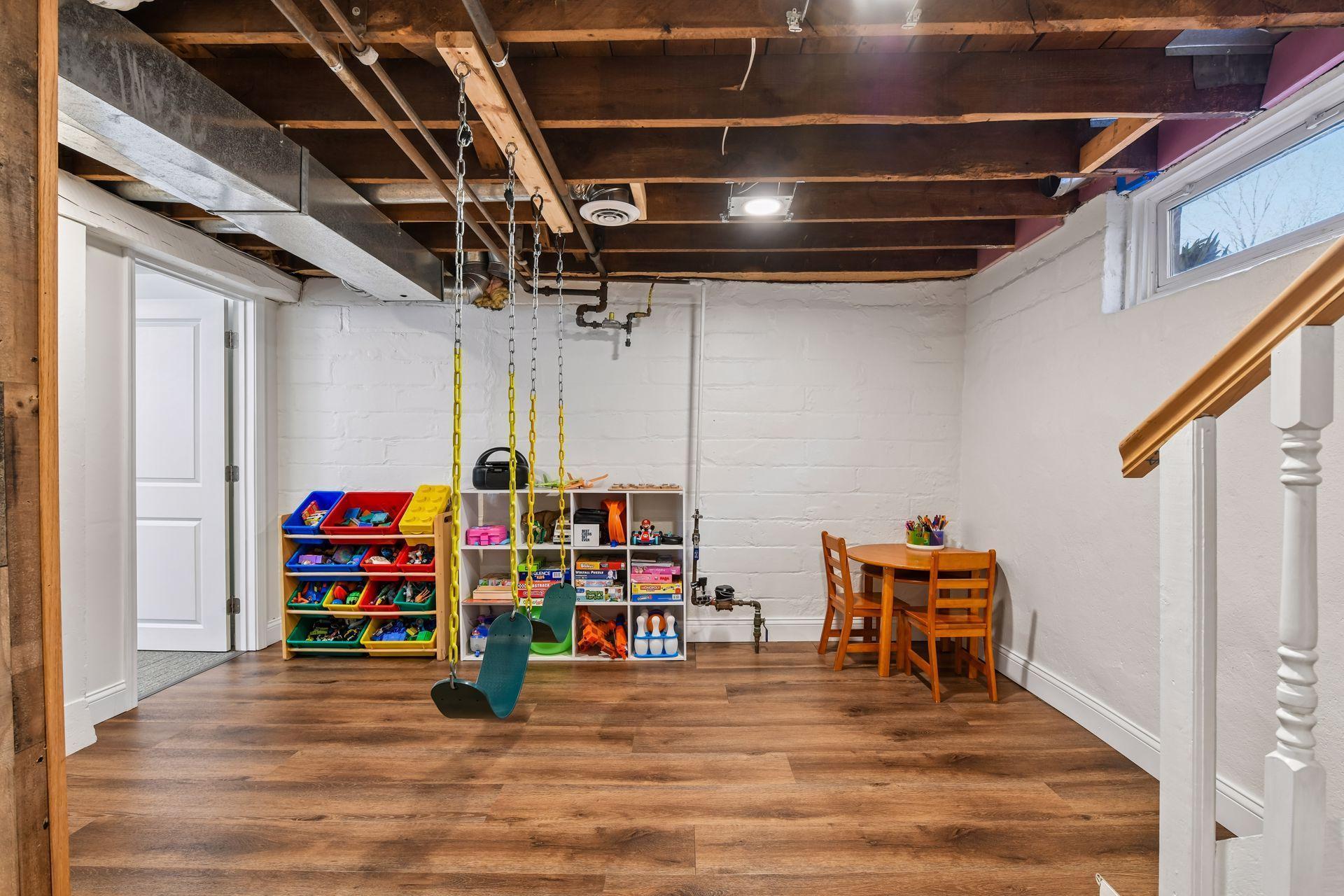 Partially finished area in basement is currently used as an indoor playroom