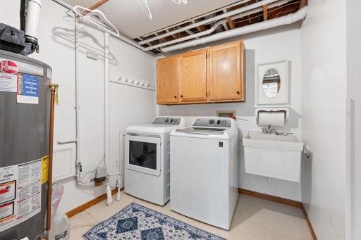 Bright laundry room in the lower level with convenient utility sink.