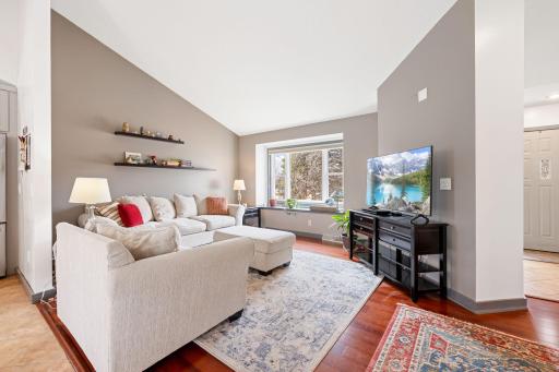 Warm & cozy living room with sunlight beaming through the bay window.