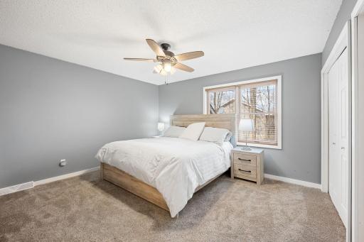 Spacious primary bedroom with private 3/4 bath and dual closets.