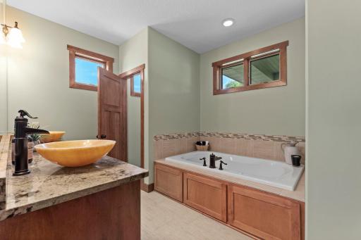 The primary ensuite bathroom features double sinks and a separate tub and walk-in shower.