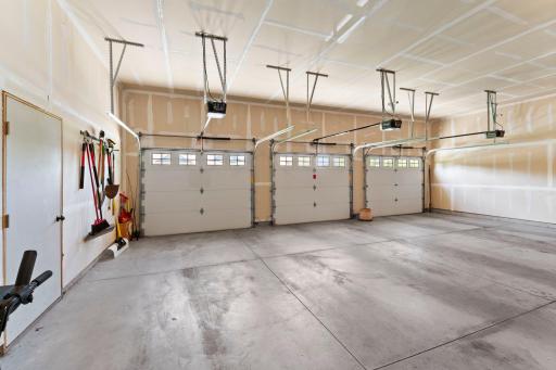 The three-car garage includes 3 garage door openers.
