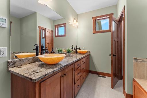 The primary ensuite bathroom features double sinks and a separate tub and walk-in shower.